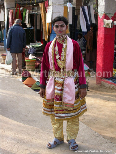 Artist posing as lord Krishna hanging out in fair ground