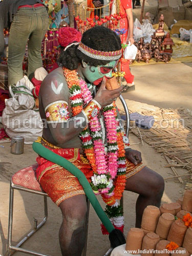 Artist posing as God Hanumaan taking sip of Tea