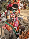 Artist posing as God Hanumaan taking sip of Tea