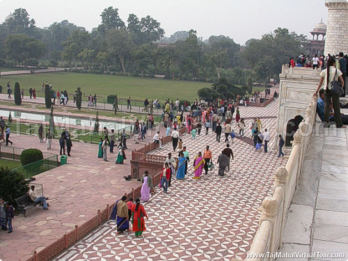 Visitors putting off their shoes before get in Taj Mahal