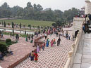 Visitors putting off their shoes before get in Taj Mahal